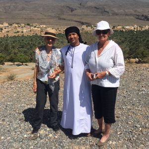 Abdullah in traditional omani dress with two female tourists