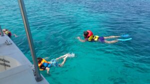 Kids snorkelling in crystal blue waters